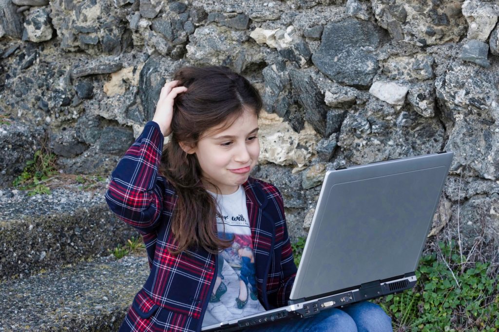 Child looking confused at a laptop. Accessibility is vital for a good website