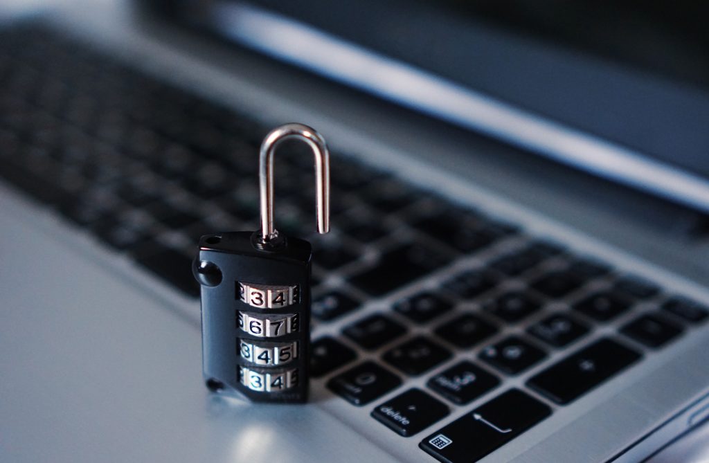 Image of a padlock next to a computer keyboard, illustrating the importance of cyber security, as part of Little Bird Creative's tips for great websites.