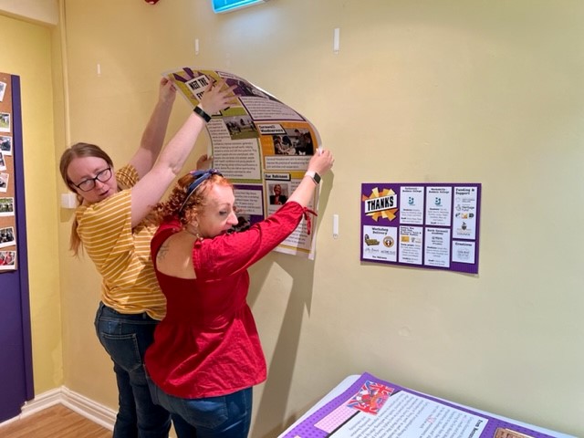 Emma and Lesley from Little Bird Creative installing a museum display they designed.