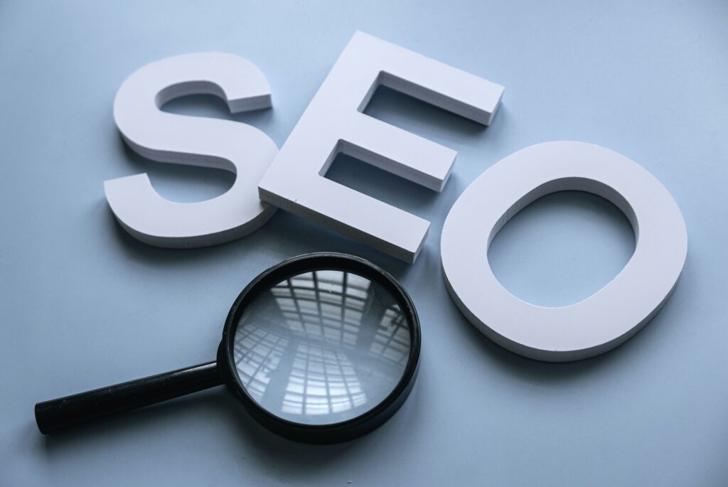 Photo of the letters S, E, O and a magnifying glass to illustrate search enging optimisation