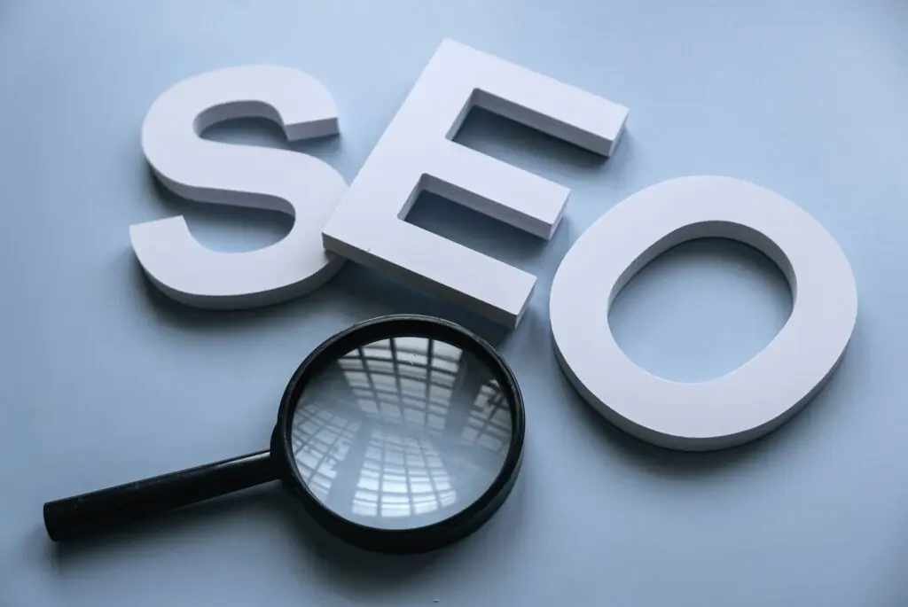Photo of the letters S, E, O and a magnifying glass to illustrate search enging optimisation