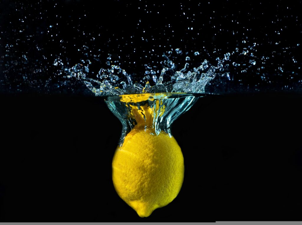 A lemon falling into water